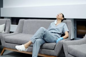 A foreign nurse sitting on a couch