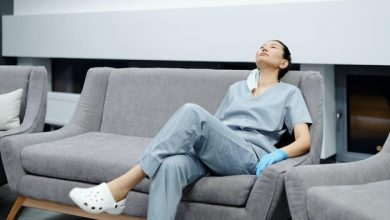 A foreign nurse sitting on a couch